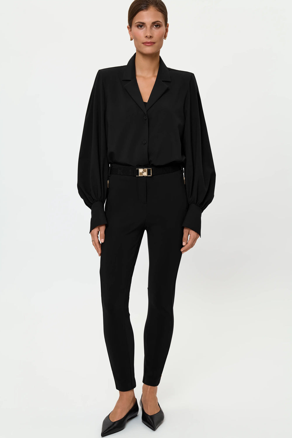 Full-length front view of the VENTA Stretch Shirt tucked into LARIX Pants, styled with a black belt and gold buckle for a sharp, polished monochrome look.