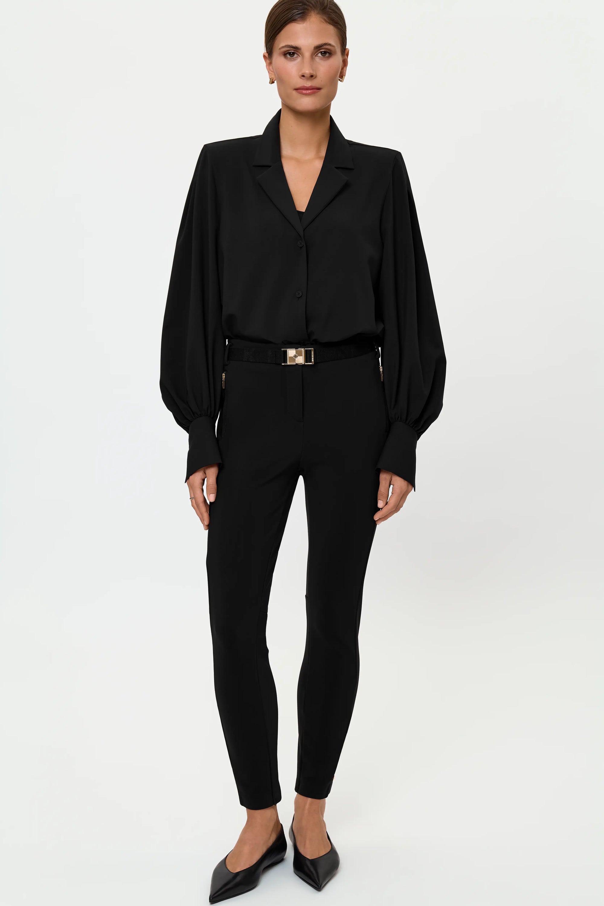 Full-length front view of the VENTA Stretch Shirt tucked into LARIX Pants, styled with a black belt and gold buckle for a sharp, polished monochrome look.