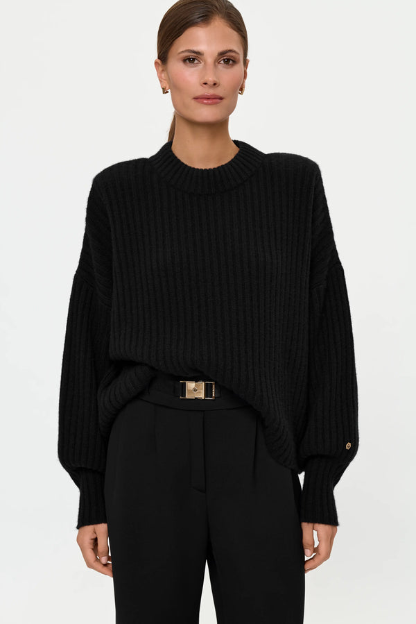Front close-up of black ribbed cashmere sweater with balloon sleeves and ribbed crew neckline.