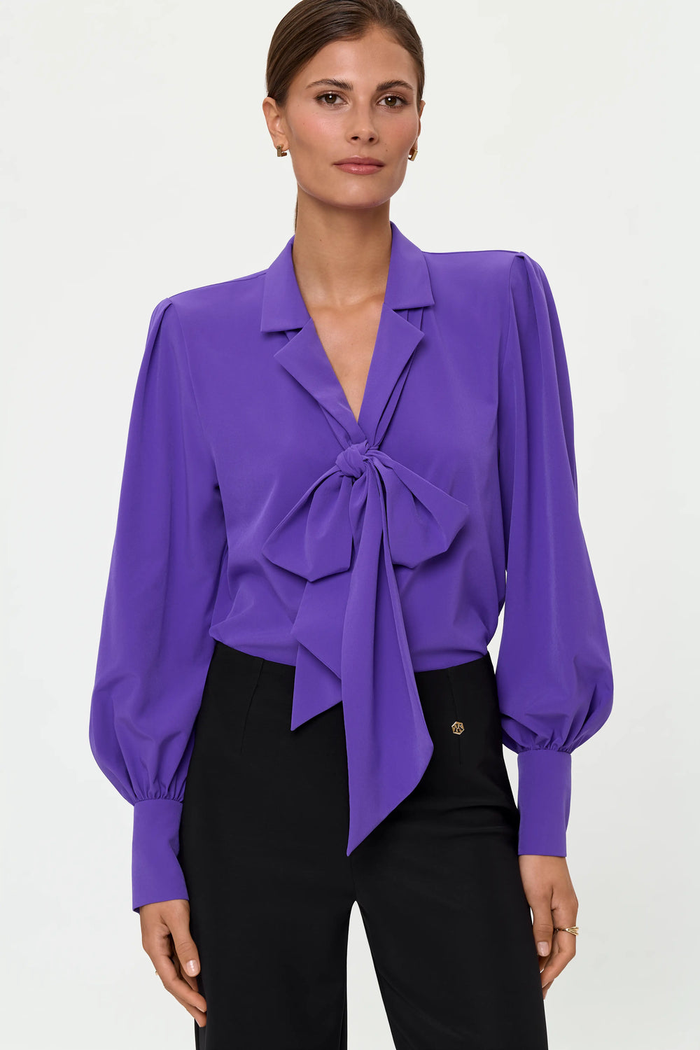 Close-up of a mystic purple blouse featuring a front bow tie, soft draping, and voluminous sleeves.