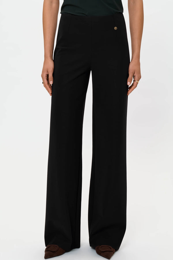 Close-up of black wide-leg pants showing full-length fit and front drape.