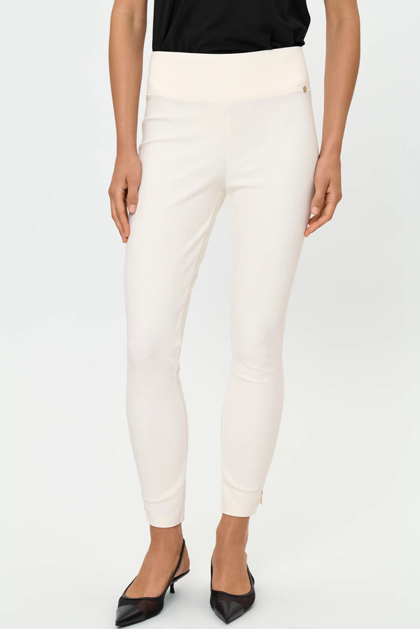 Close-up front view of ivory stretch pants showing the smooth high-rise waistband and gold logo detail.